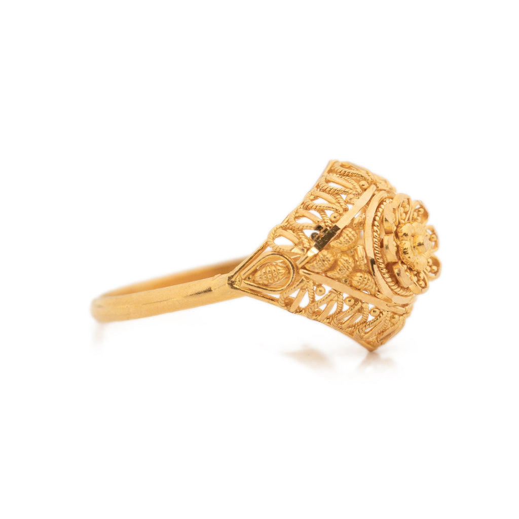 gold ring with a skull and a red stone